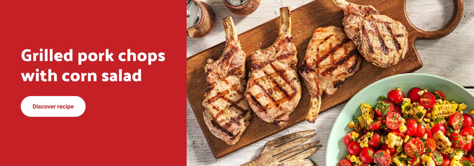 Text reading: "Grilled pork chops with corn salad. Discover recipe.' Image shows four grilled pork chops on a wooden board beside a bowl of corn and tomato salad."